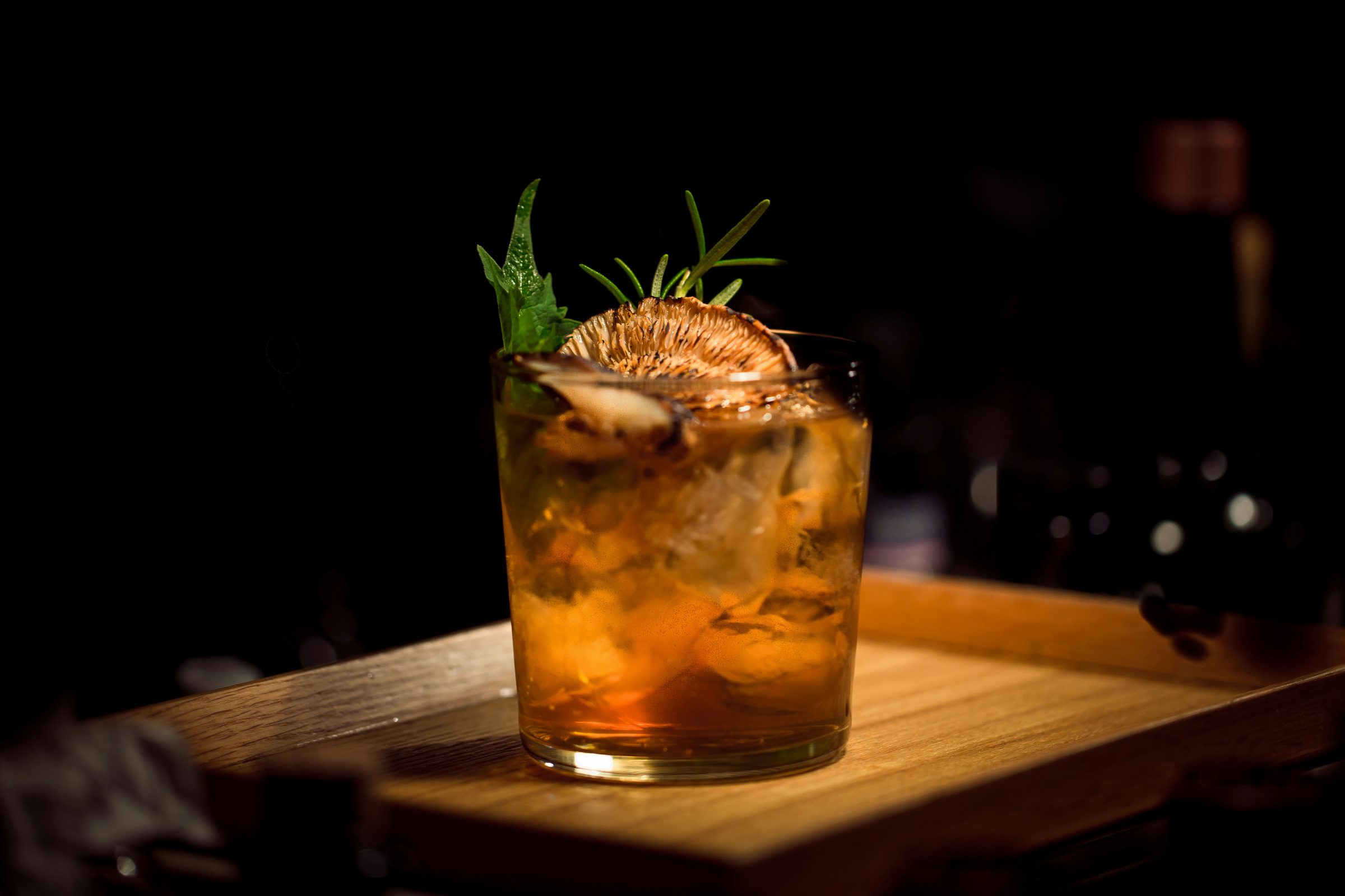 A finished beverage served over ice in a glass, garnished and ready at the counter